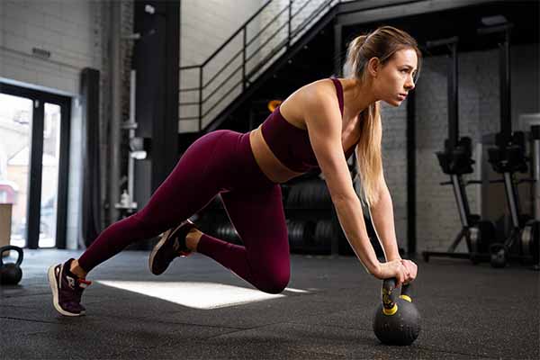 Woman doing exercise with Kettlebells