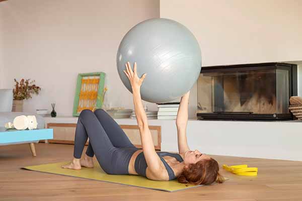 Woman doing exercise with medicine ball 