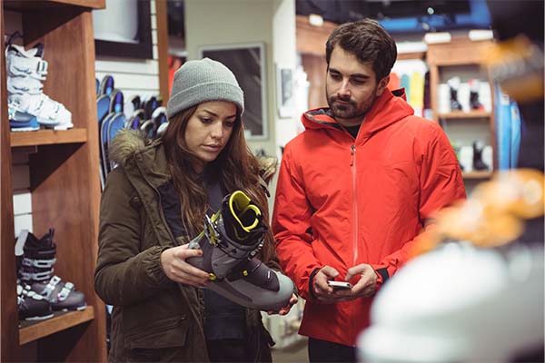 Couple buying gears for outdoor adventure