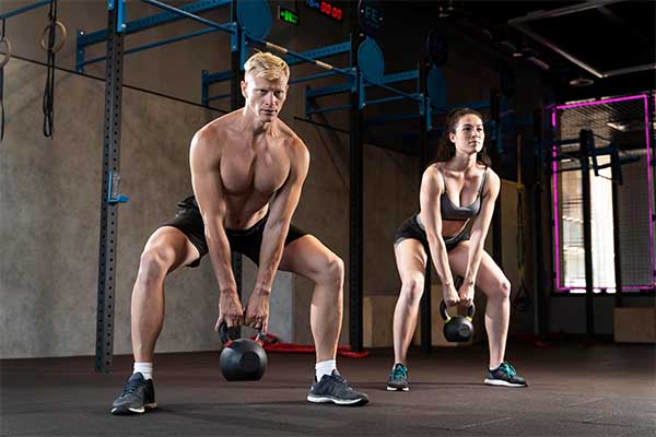 couple doing weight training workouts