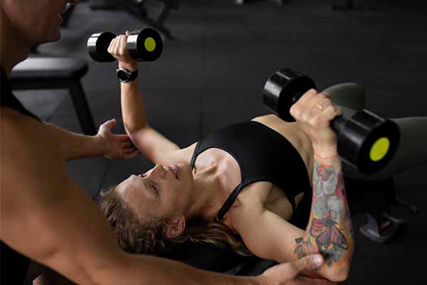 woman training with dumbbells