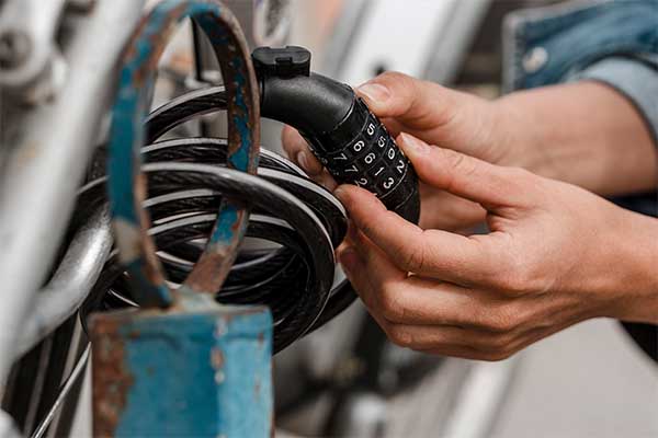 Bike accessories: Woman putting a bike lock
