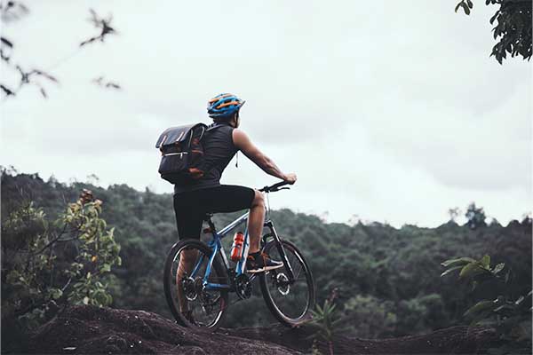 Bike Accessories: Cyclist On Sunny Day with bag. Bike Adventure Travel Photo