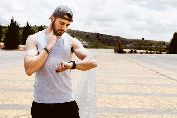 A male athlete using smart watch