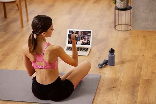 Fitness trend: woman with laptop at home
