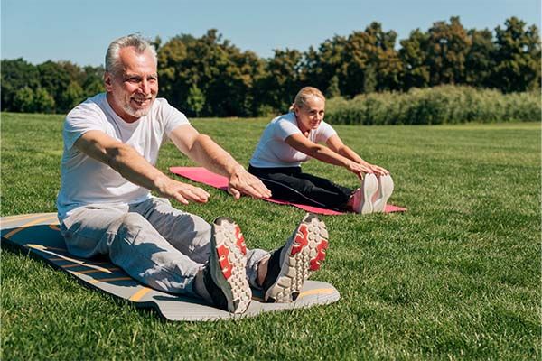 Old couple practicing yoga  