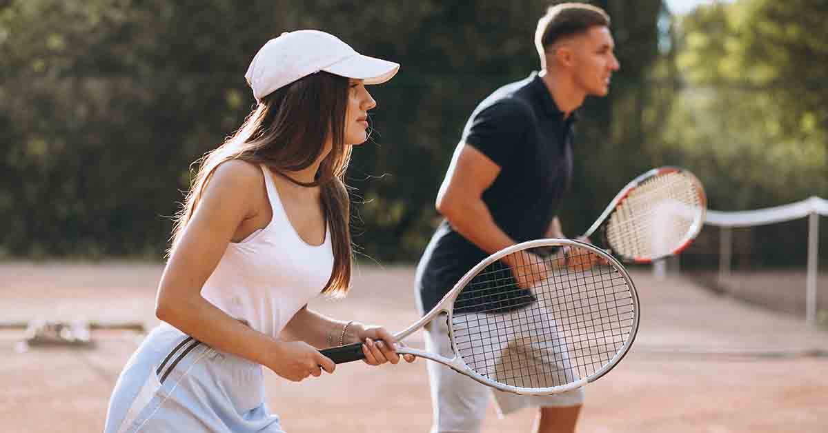 Man and woman playing tennis