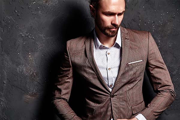 handsome fashion stylish hipster businessman model dressed in elegant brown suit
