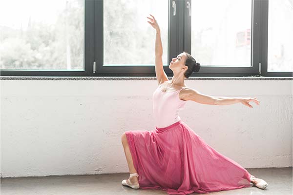 Ballerina dancer dancing near the window