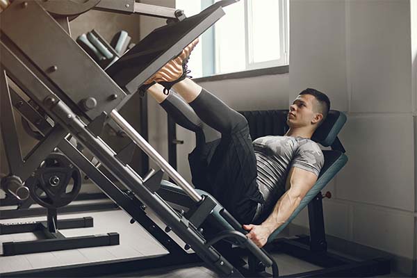 man is training for hiking in a gym