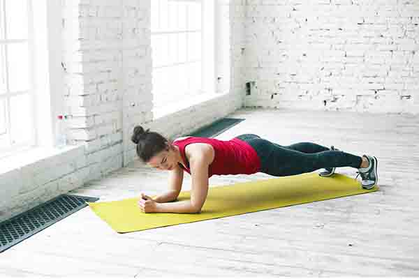 Doing plank for toned body 