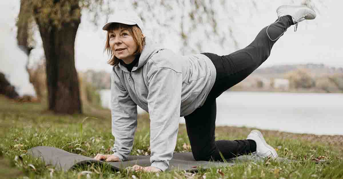 Elderly woman working out outdoors