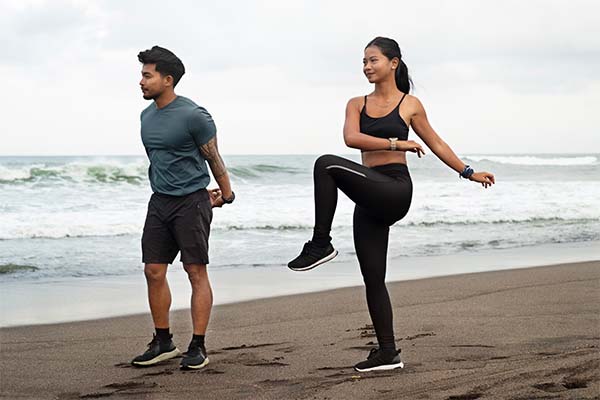 people stretching on beach