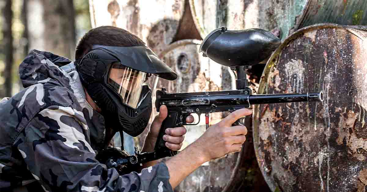 A man with a gun playing paintball