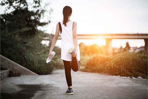 Young fitness woman hand holding water bottle after running exercise
