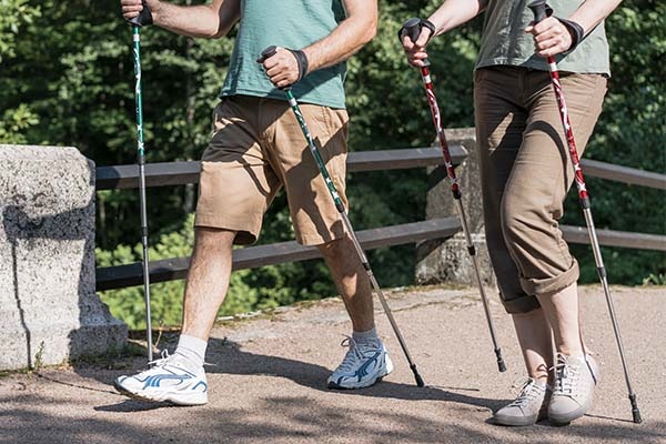 Elderly couple using walking poles
