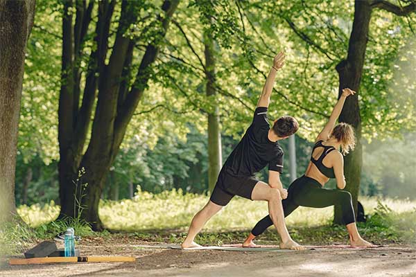 Young sportive couple doing yoga fitness