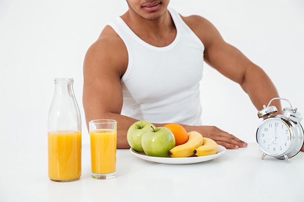 young sportsman near fruits