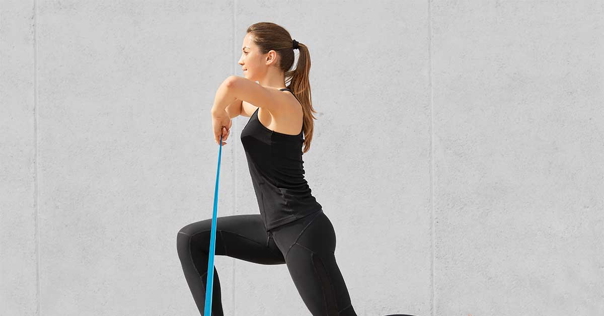 Self determined bodybuilder does exercises with a resistance band